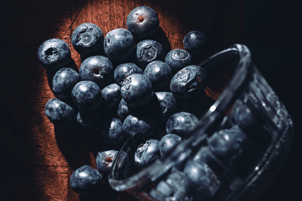 Editorial close-up photography of fresh blueberries with artistic lighting.